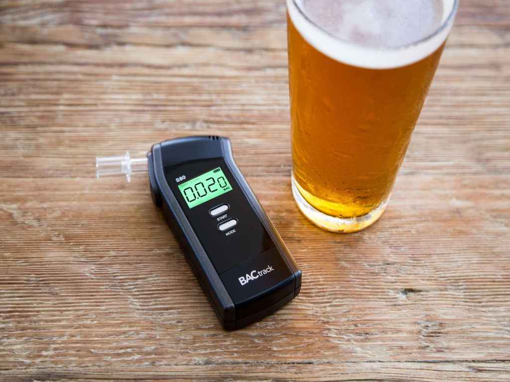 BACtrack S80 Pro with a glass of alcohol