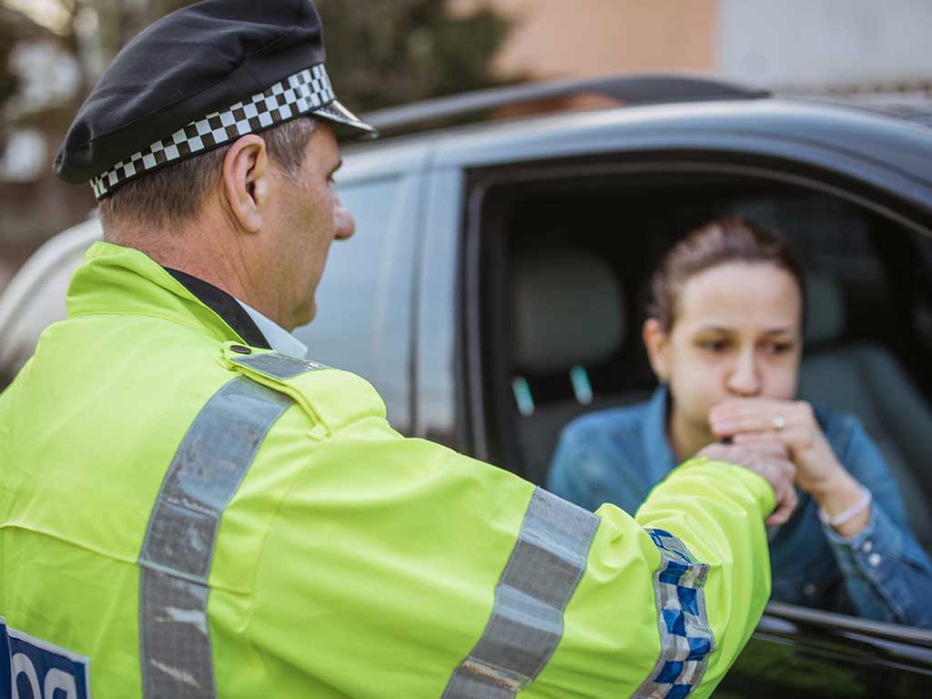 A police officer conducting a roadside breath testing